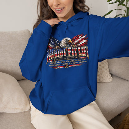 A woman wearing a PATRIOT FIT LIFE royal blue hoodie with a patriotic eagle with American flag-patterned wings graphic with a dictionary-style definition on the front.