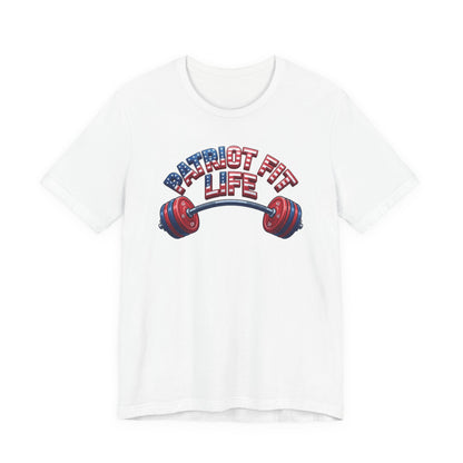 A white short-sleeve crewneck t-shirt featuring a graphic on the chest with the text 'PATRIOT FIT LIFE' in red, white, and blue lettering above a barbell with red and blue weight plates.