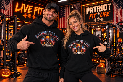 A man and a woman posing in a gym wearing matching black hoodies with a patriotic 'Patriot Fit Life' Halloween vibe graphic on the chest, pointing at their respective designs.