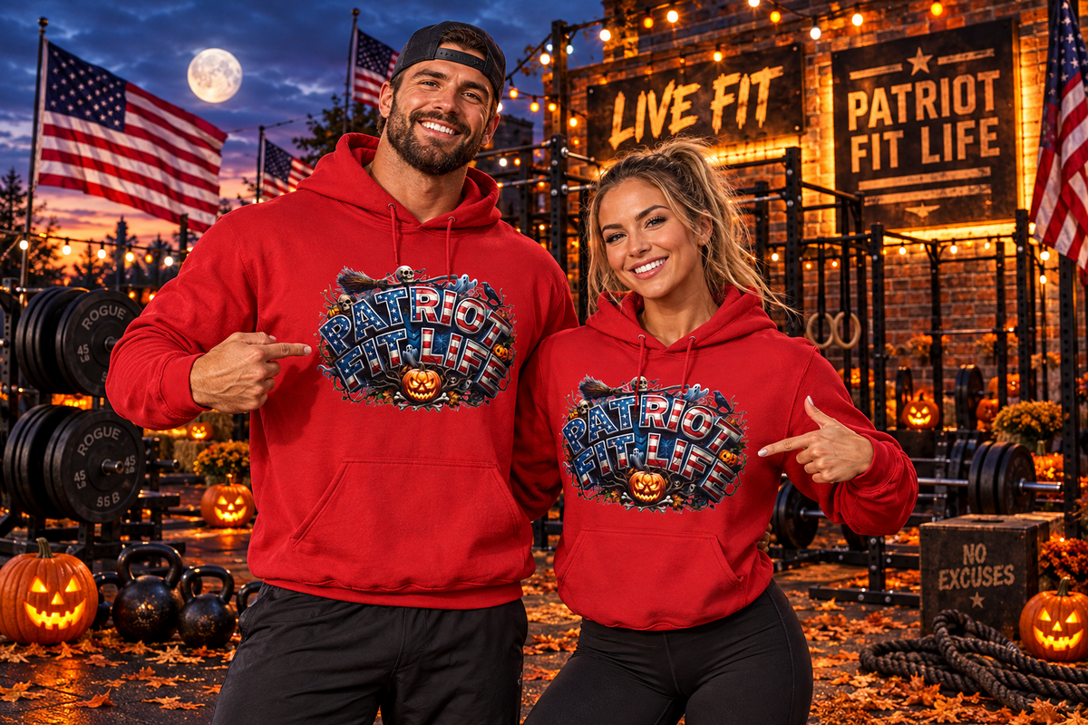 A man and a woman pose together in a patriotic Halloween-themed gym setting, both wearing matching red hoodies with a graphic that reads 'Patriot Fit Life' and with a jack-o'-lantern. The background features weight equipment, American flags, pumpkins, and a lit 'LIVE FIT and PATRIOT FIT LIFE' sign.