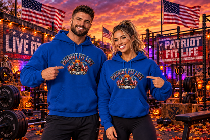 A man and a woman standing in a gym at sunset wearing matching royal blue hoodies with a patriotic Halloween graphic that reads 'PATRIOT FIT LIFE.