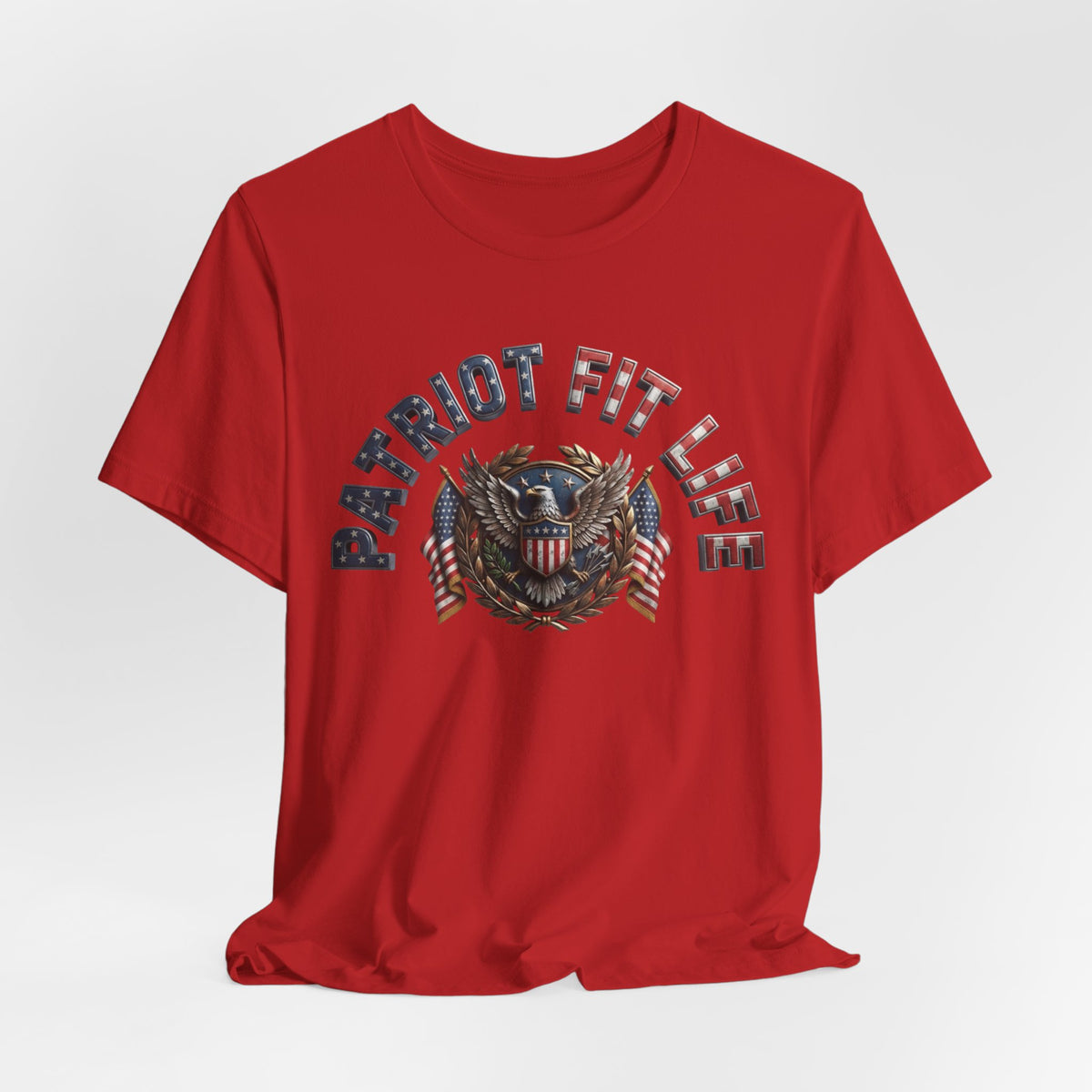 A red short-sleeve crewneck t-shirt with a distressed graphic on the chest reading 'PATRIOT FIT LIFE' in blue and white, surrounding an eagle crest with American flags.