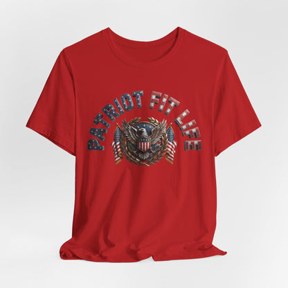 A red short-sleeve crewneck t-shirt with a distressed graphic on the chest reading 'PATRIOT FIT LIFE' in blue and white, surrounding an eagle crest with American flags.