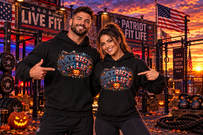 A man and a woman posing together in a gym at sunset, both wearing matching black hoodies with a colorful patriotic 'Patriot Fit Life' Halloween graphic on the front.