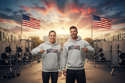 A man and a woman standing in a gym setting wearing matching light gray hoodies with 'PATRIOT' printed across the chest. The background features the White House, American flags, weight racks, and a dramatic sunset sky.