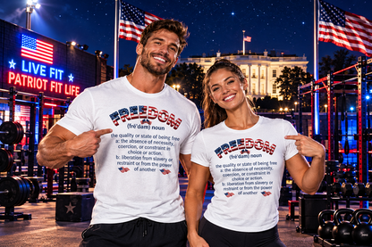 A man and a woman standing together in a gym at night, both wearing matching white graphic T-shirts with a patriotic red, white, and blue design and the word 'FREEDOM' printed on the front. The background shows a lit-up fitness center with American flags, weights, and the White House in the distance.