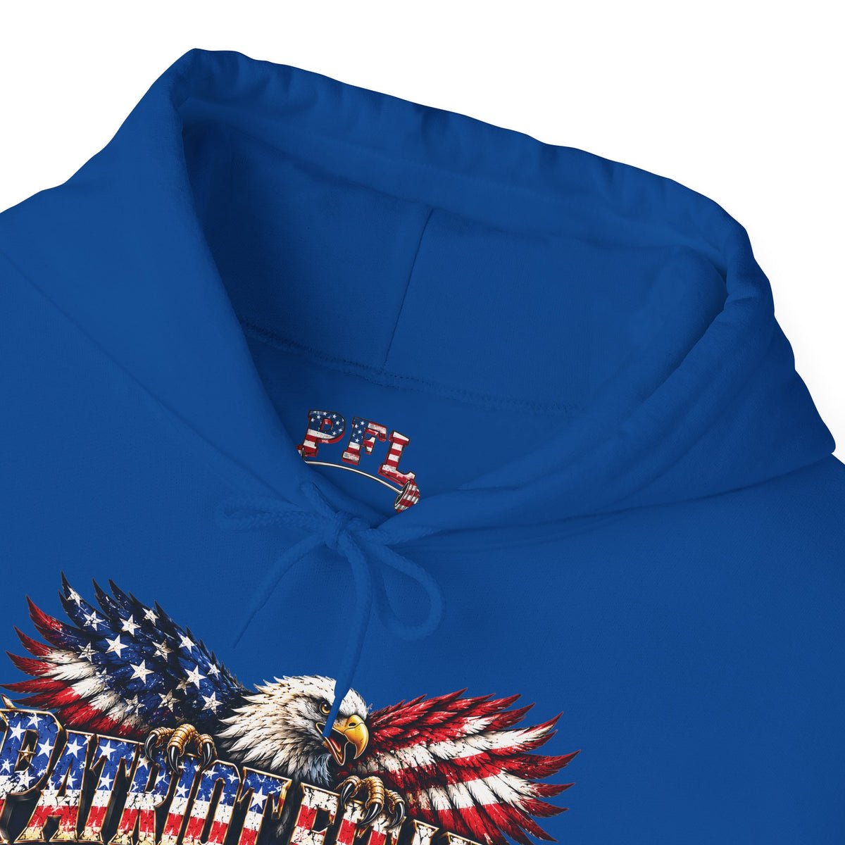A close-up of a royal blue hoodie featuring a detailed graphic of an eagle with wings patterned like the American flag and the word 'PATRIOT FIT LIFE' printed below. A small PFL (Patriot Fit Life) logo is visible on the inside neck label.