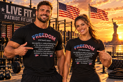 Two smiling fit people standing in a gym at sunset wearing matching black T-shirts with a patriotic 'FREEDOM' graphic and American flag details. Background includes flags, weights, and Statue of Liberty at sunset.