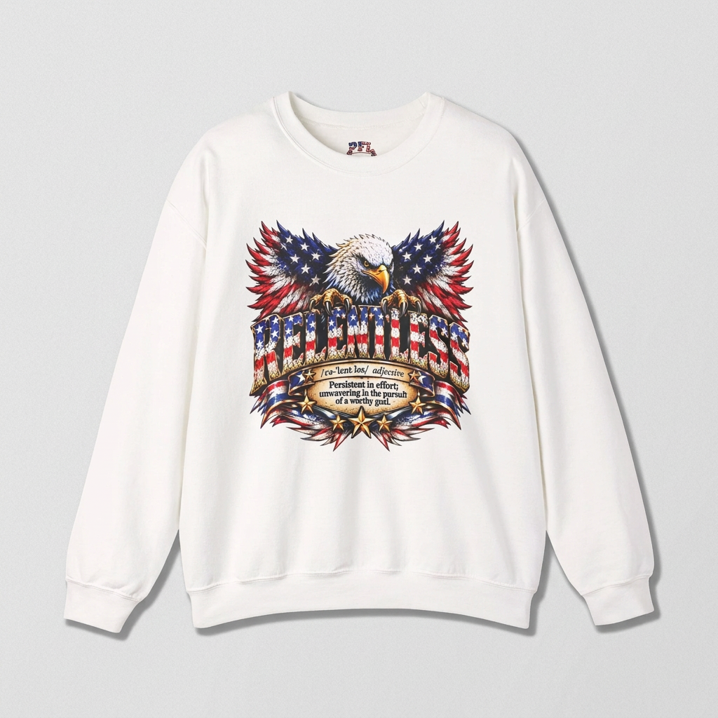 A white crewneck sweatshirt featuring a large patriotic RELENTLESS graphic of an eagle perched on an American flag banner with a dictionary-style definition below.
