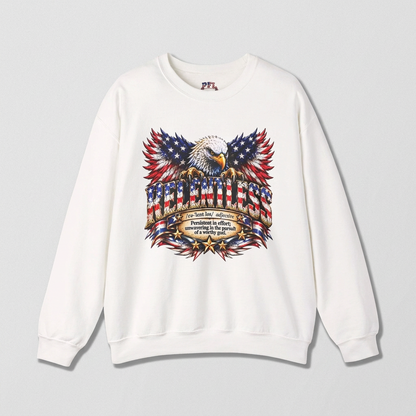 A white crewneck sweatshirt featuring a large patriotic RELENTLESS graphic of an eagle perched on an American flag banner with a dictionary-style definition below.