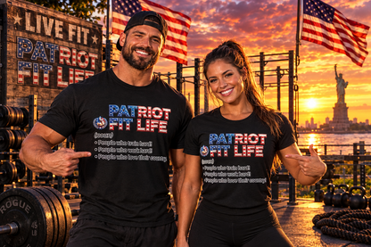 Two smiling fitness coaches posing together in a gym setting at sunset, wearing matching black t-shirts with the text 'PATRIOT FIT LIFE' and a list of values. The background features a Statue of Liberty, New York City skyline, American flags, and gym equipment.