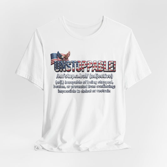 A white short-sleeve crewneck t-shirt with a graphic print on the front. The graphic features the word 'UNSTOPPABLE!' in a distressed red, white, and blue font, accompanied by a small American flag and eagle illustration, followed by a dictionary definition of the word 'unstoppable' in black text.