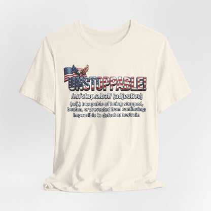 An off-white crewneck t-shirt with a graphic print on the front featuring the word 'UNSTOPPABLE!' in a distressed American flag font, an eagle graphic, and a dictionary definition of the word 'unstoppable' underneath.