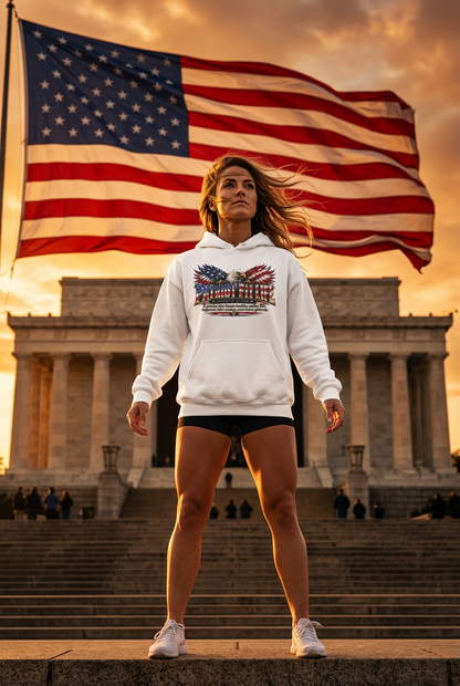 A woman stands on the steps of the Lincoln Memorial wearing a white hoodie with a patriotic Patriot Fit Life American flag graphic, black athletic shorts, and white sneakers, with a large American flag waving in the background against a golden sunset sky.