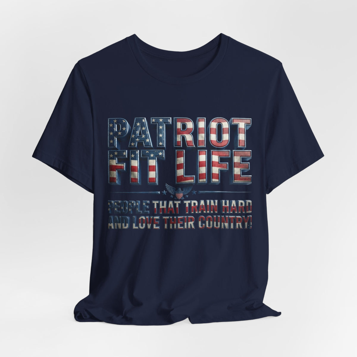 A navy blue short-sleeve t-shirt with a distressed patriotic graphic on the front reading 'PATRIOT FIT LIFE' and 'PEOPLE THAT TRAIN HARD AND LOVE THEIR COUNTRY!'. The graphic features red, white, and blue American flag-inspired lettering.