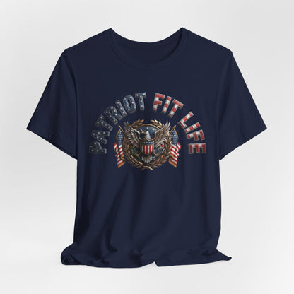 A navy blue short-sleeve crewneck t-shirt featuring a patriotic graphic on the chest with the text 'PATRIOT FIT LIFE' and an eagle emblem with American flag details, shown against a light gray background.