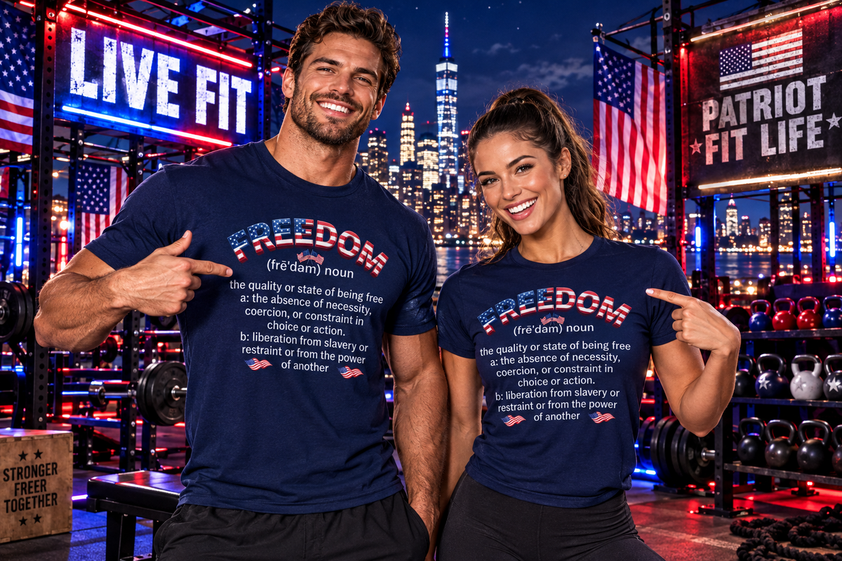 A man and a woman pose together in a gym setting at night, both wearing matching navy blue t-shirts with a humorous dictionary-style definition of 'FREEDOM' printed on the front. The background features a city skyline, American flags, and gym equipment.