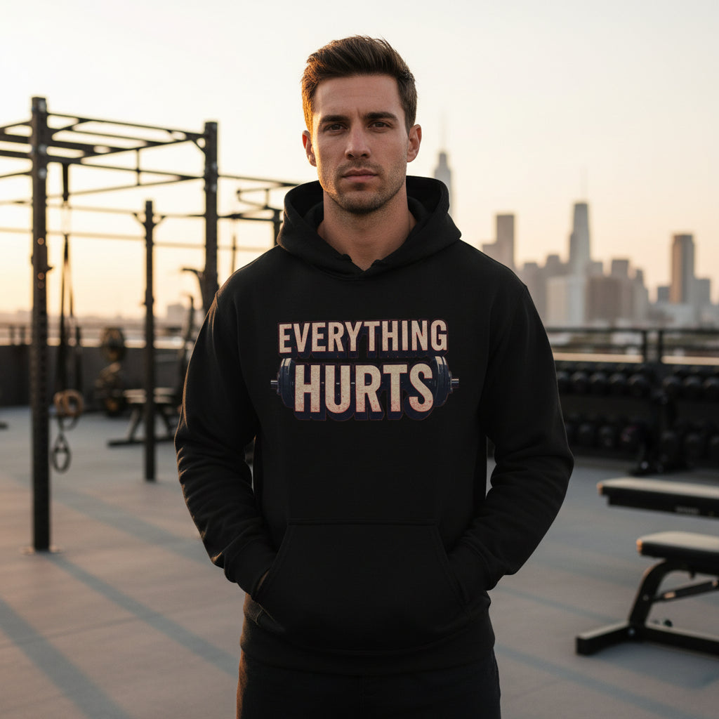 Person wearing a black hoodie with 'EVERYTHING HURTS' text and barbell graphic.