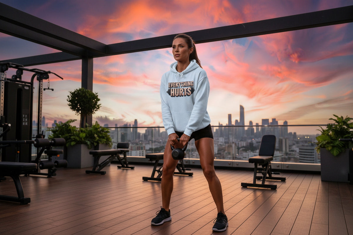 Light blue hoodie with 'Everything Hurts' text and a barbell graphic with a gym skyline background.