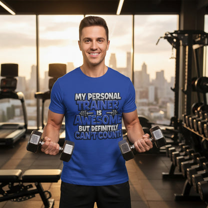 Man in a gym wearing a blue t-shirt with text that says, My Personal Trainer Is Awesome But Definitely Can't Count! a humorous message. 