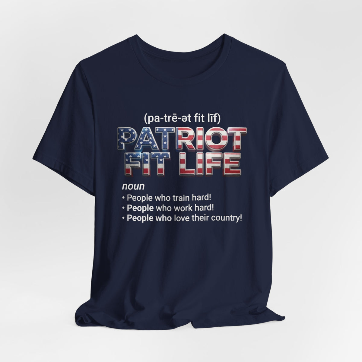 A navy blue short-sleeve t-shirt with a graphic print on the front. The graphic features the text '(pa-tré-ot fit lif)' above 'PATRIOT FIT LIFE' in a red, white, and blue American flag pattern, followed by a dictionary definition below.