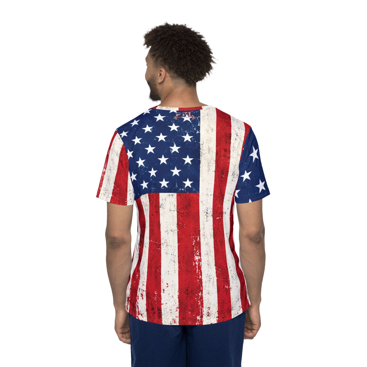 A man viewed from the back wearing a distressed American flag t-shirt design, set against a plain white background.