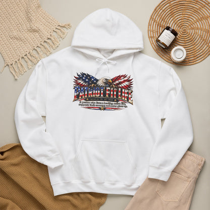 A white pullover hoodie laid flat on a neutral beige surface, featuring a large front PATRIOT FIT LIFE eagle American flag dictionary-style definition graphic. 