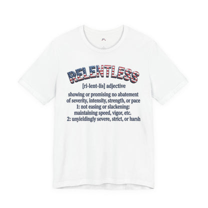 A white short-sleeve crewneck t-shirt featuring a graphic print on the front. The graphic displays the word 'RELENTLESS' in a distressed American flag pattern, followed by a dictionary definition printed in dark navy blue text.