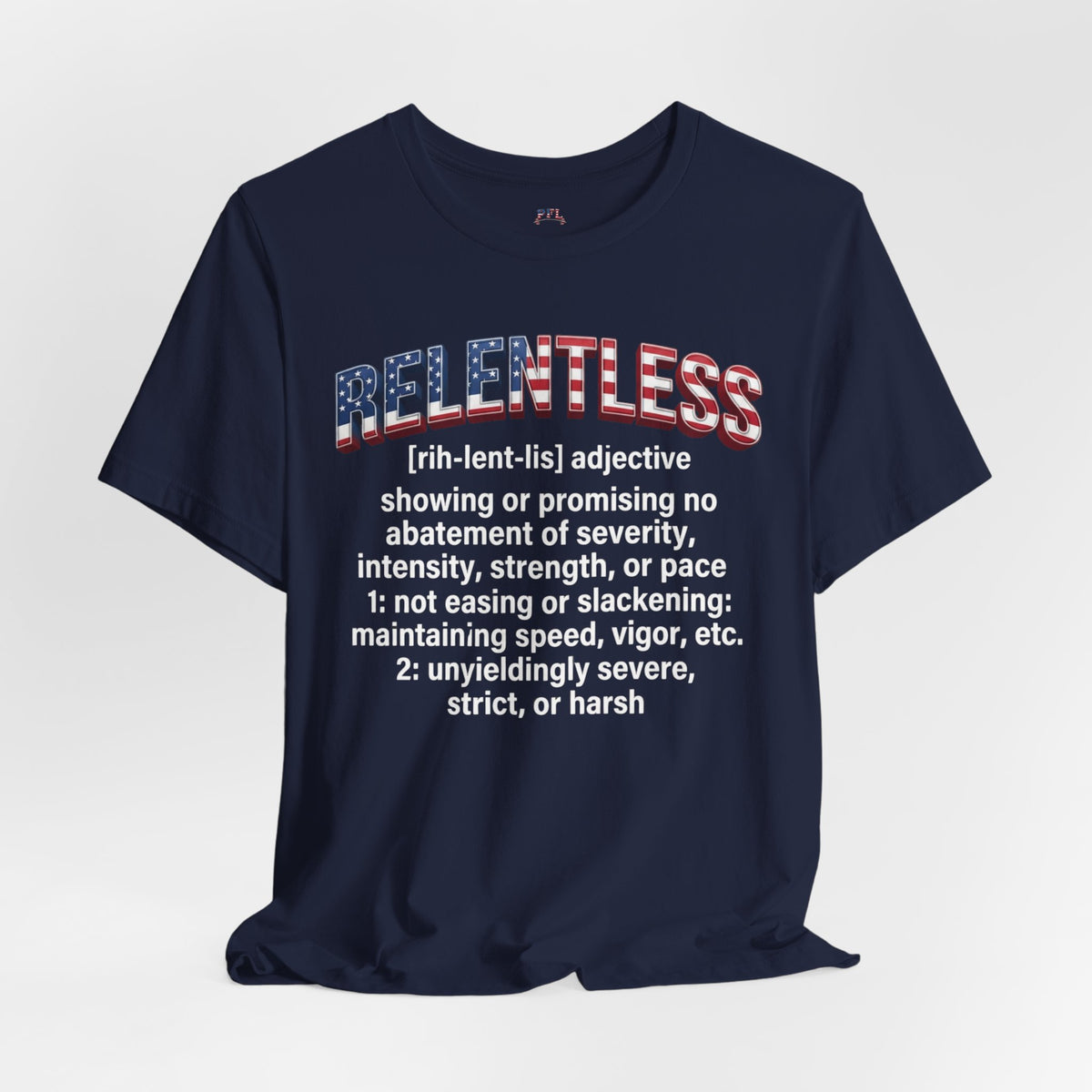 A navy blue short-sleeve graphic T-shirt displayed against a light gray background. The shirt features a large graphic on the chest with the word 'RELENTLESS' in an American flag pattern, followed by a dictionary definition printed in white text.