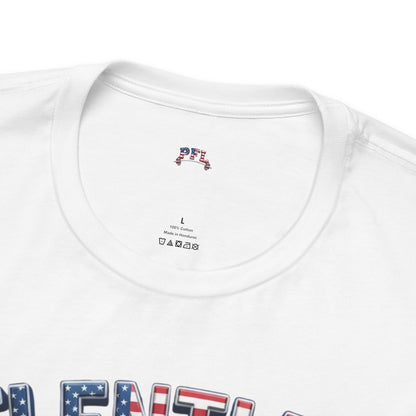 Close-up of a white short-sleeve t-shirt showing the inner neck label with a small red, white, and blue graphic, and part of a patriotic red, white, and blue graphic on the lower front.