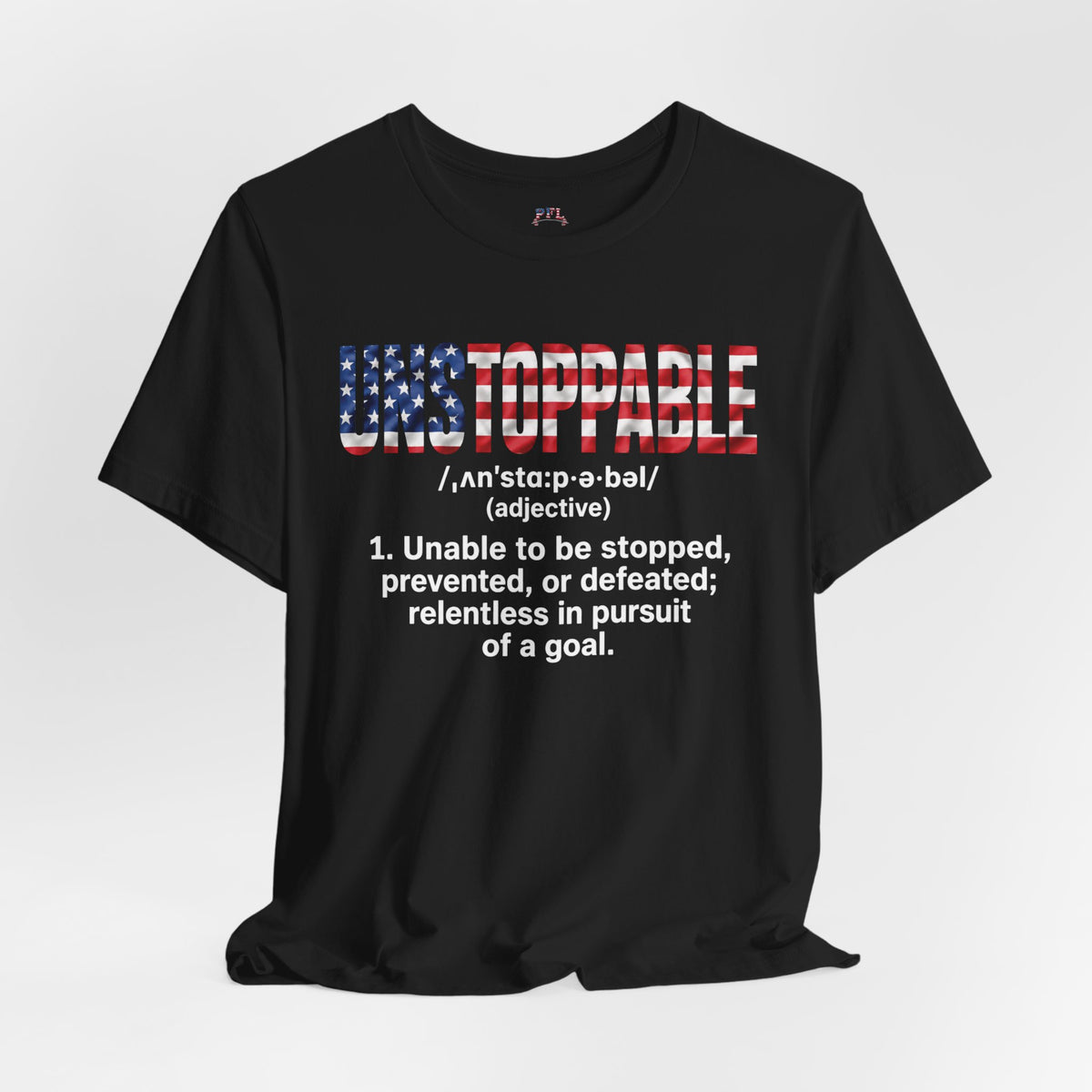 A black short-sleeve t-shirt with a graphic on the front. The graphic features the word 'UNSTOPPABLE' in a distressed American flag pattern (red, white, and blue) with a dictionary definition printed below in white text.