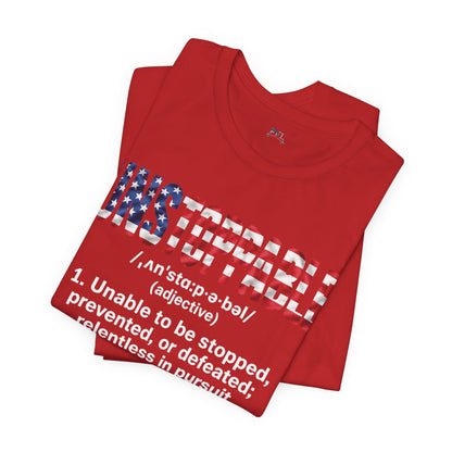 A folded red t-shirt with an UNSTOPPABLE graphic design featuring a distressed American flag pattern and white text, displayed on a clean white background.