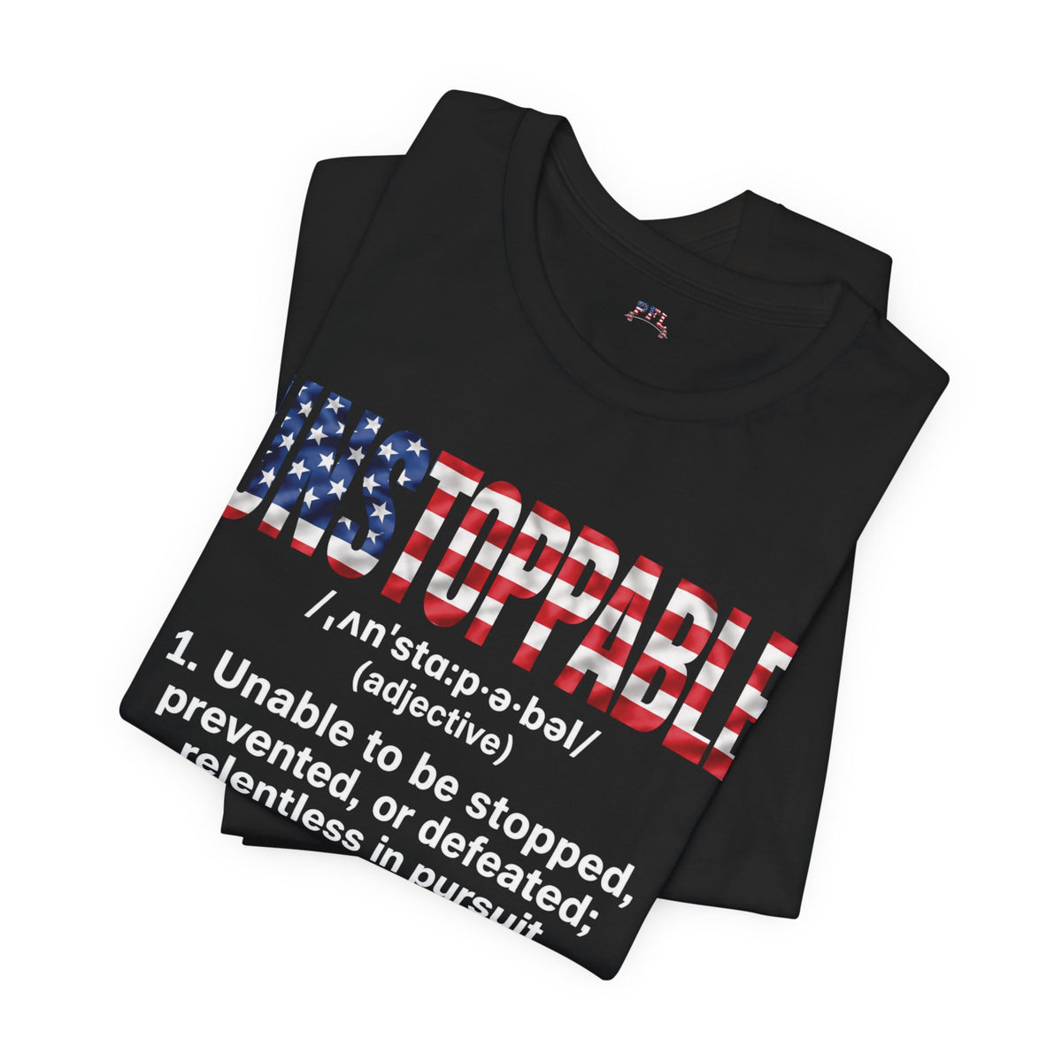 A folded black t-shirt featuring a graphic design with the word 'UNSTOPPABLE' styled in an American flag pattern and a dictionary definition printed below in white.