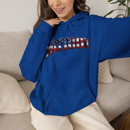 A woman wearing a royal blue hoodie with a patriotic 'PATRIOT' graphic across the chest, sitting on a beige couch.