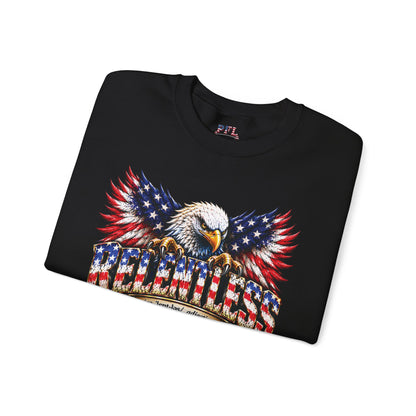 A folded black crewneck t-shirt featuring a large graphic print of an American bald eagle with wings patterned like the US flag, perched on a wooden fence with 'RELENTLESS' spelled out in flag-styled letters. The neck label shows the brand 'PFL'.