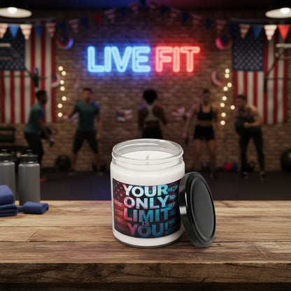 Candle with the motivational label Your Only Limit Is You! on a wooden table with an American flag and 'Live Fit' banner in the background. 